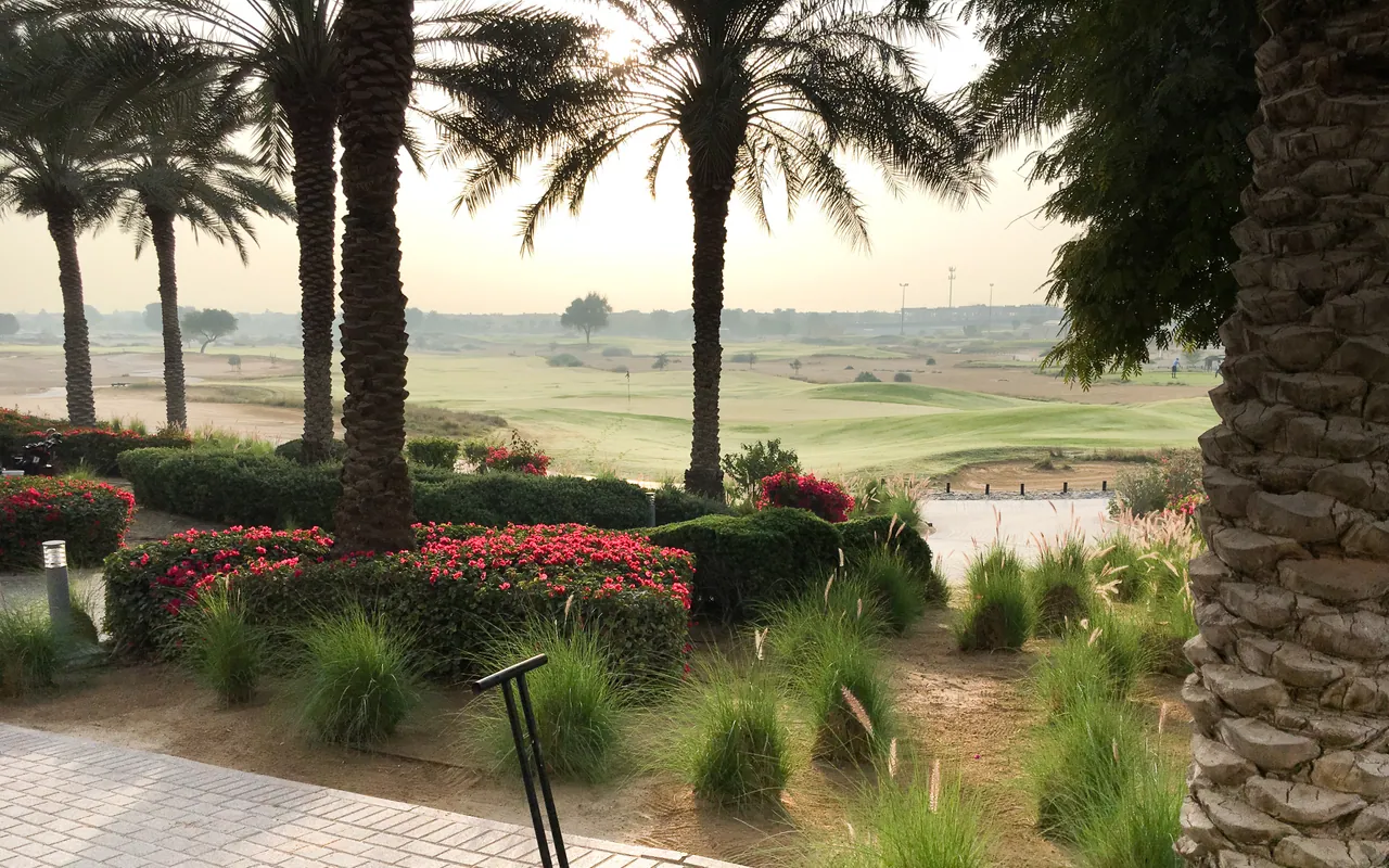 Palm trees and gardens overlooking Arabian Ranches golf course, Dubai