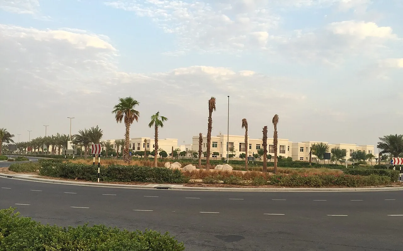 Representative Abu Dhabi community photograph: villas behind a palm-lined road in Al Ghadeer