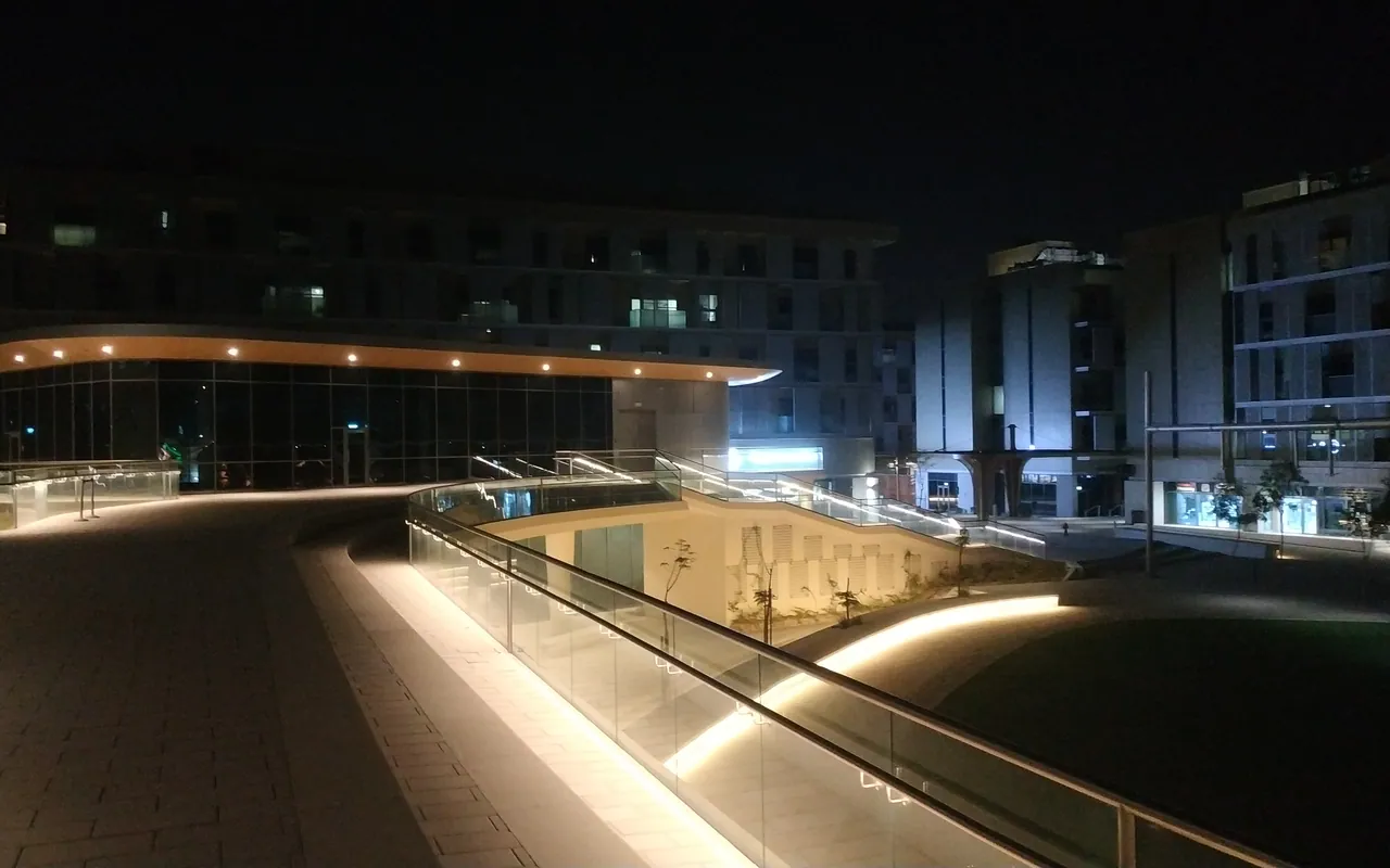 Contemporary courtyard and illuminated walkways in Masdar City at night