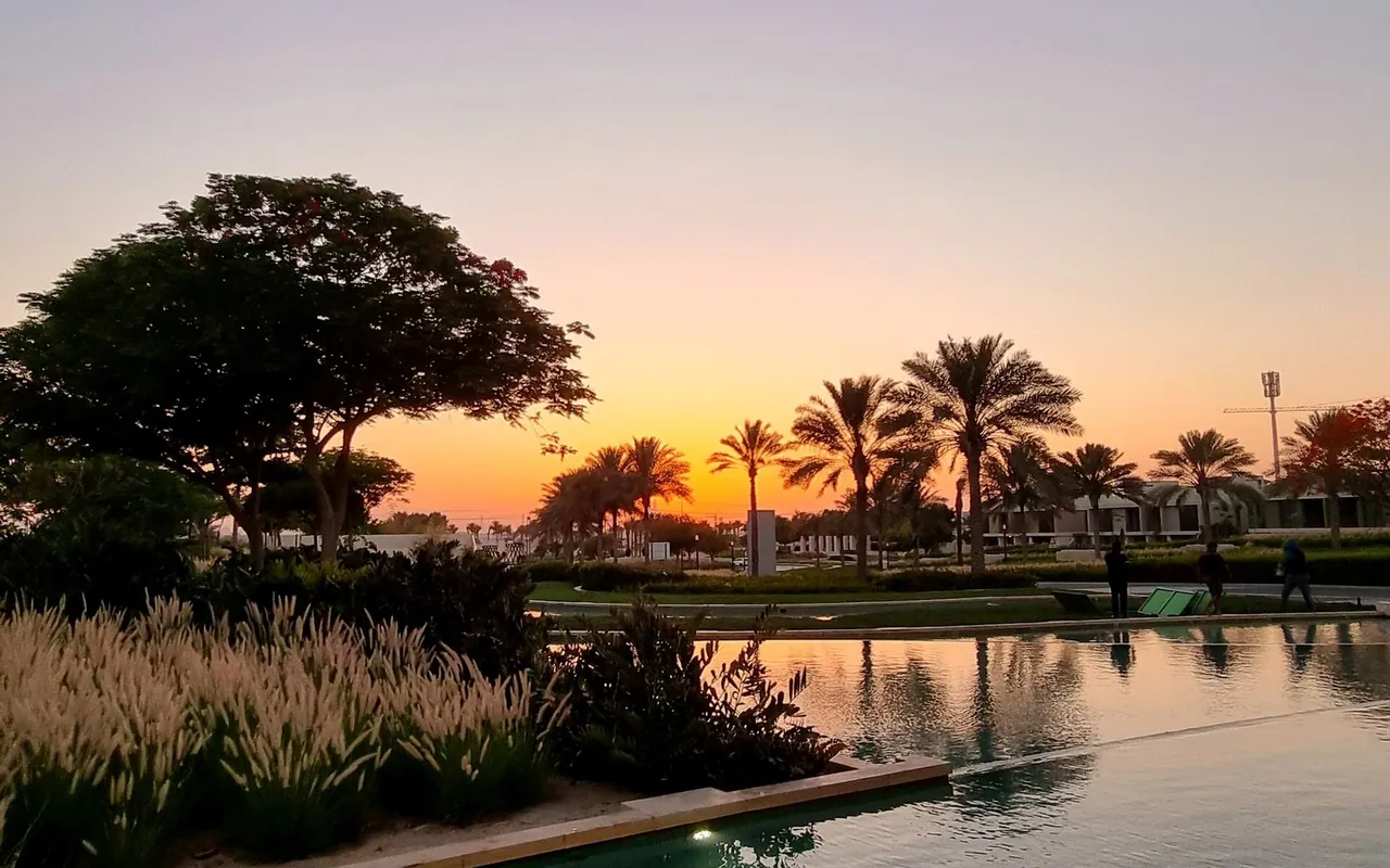 Landscaped Dubai entrance and water feature at sunset