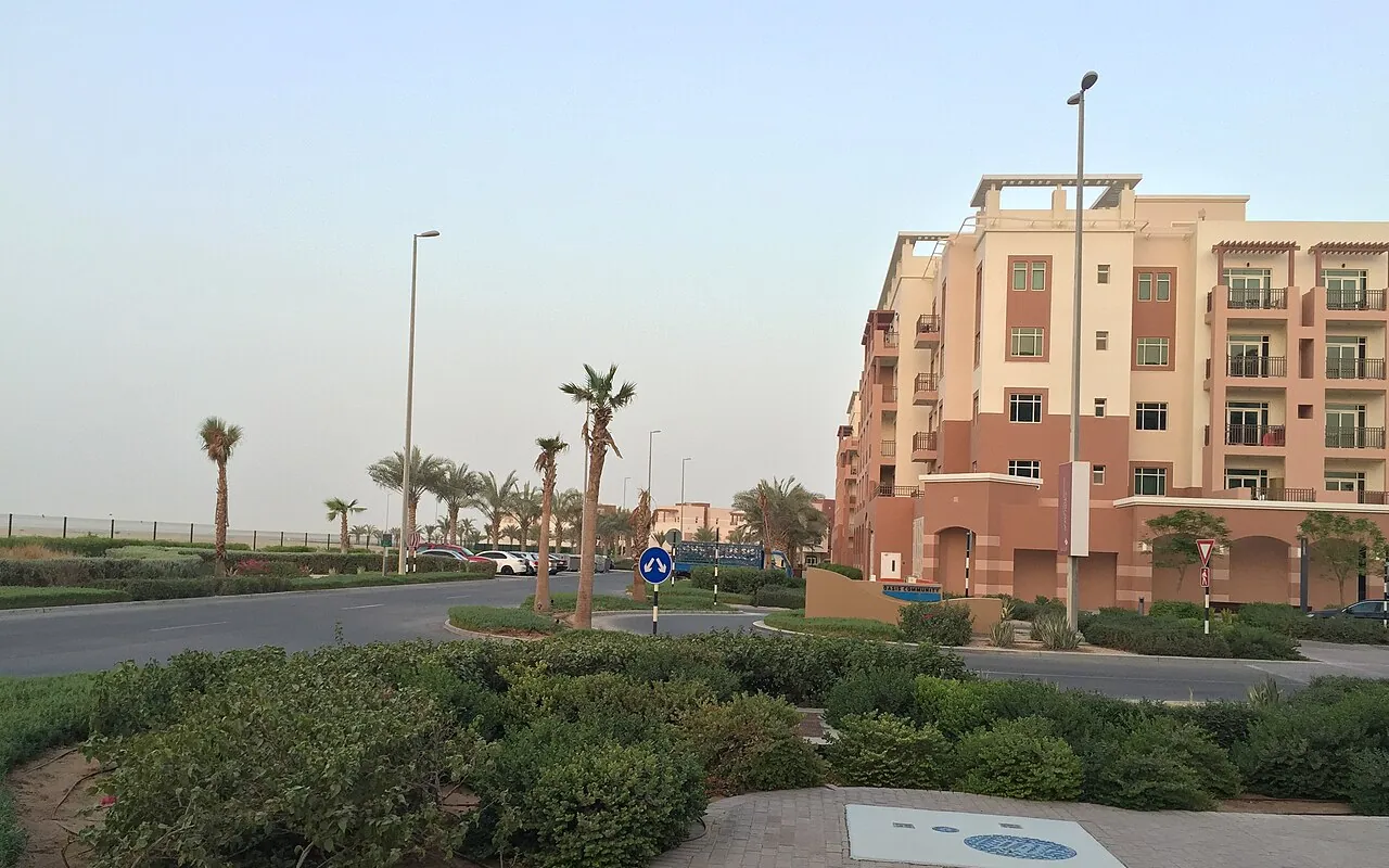 Representative Abu Dhabi community photograph: landscaped gardens and low-rise apartments in Al Ghadeer