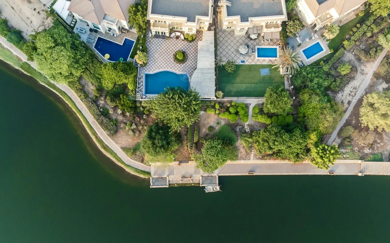 Aerial view of villas, pools and lakeside gardens in Jumeirah Islands, Dubai — representative Dubai photograph, not a view of The Springs