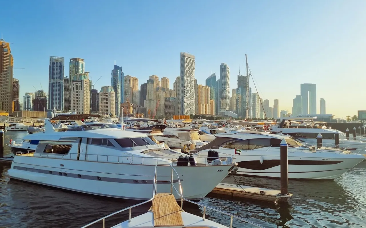 Yachts moored at Dubai Marina with the waterfront skyline beyond
