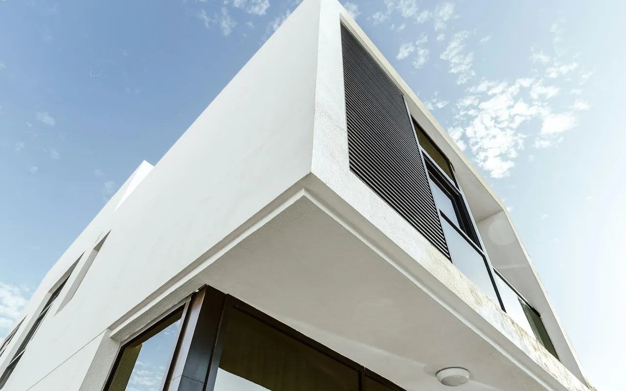 Modern white residential architecture beneath blue sky in Dubai — representative Dubai photograph, not a view of Arabian Ranches 3
